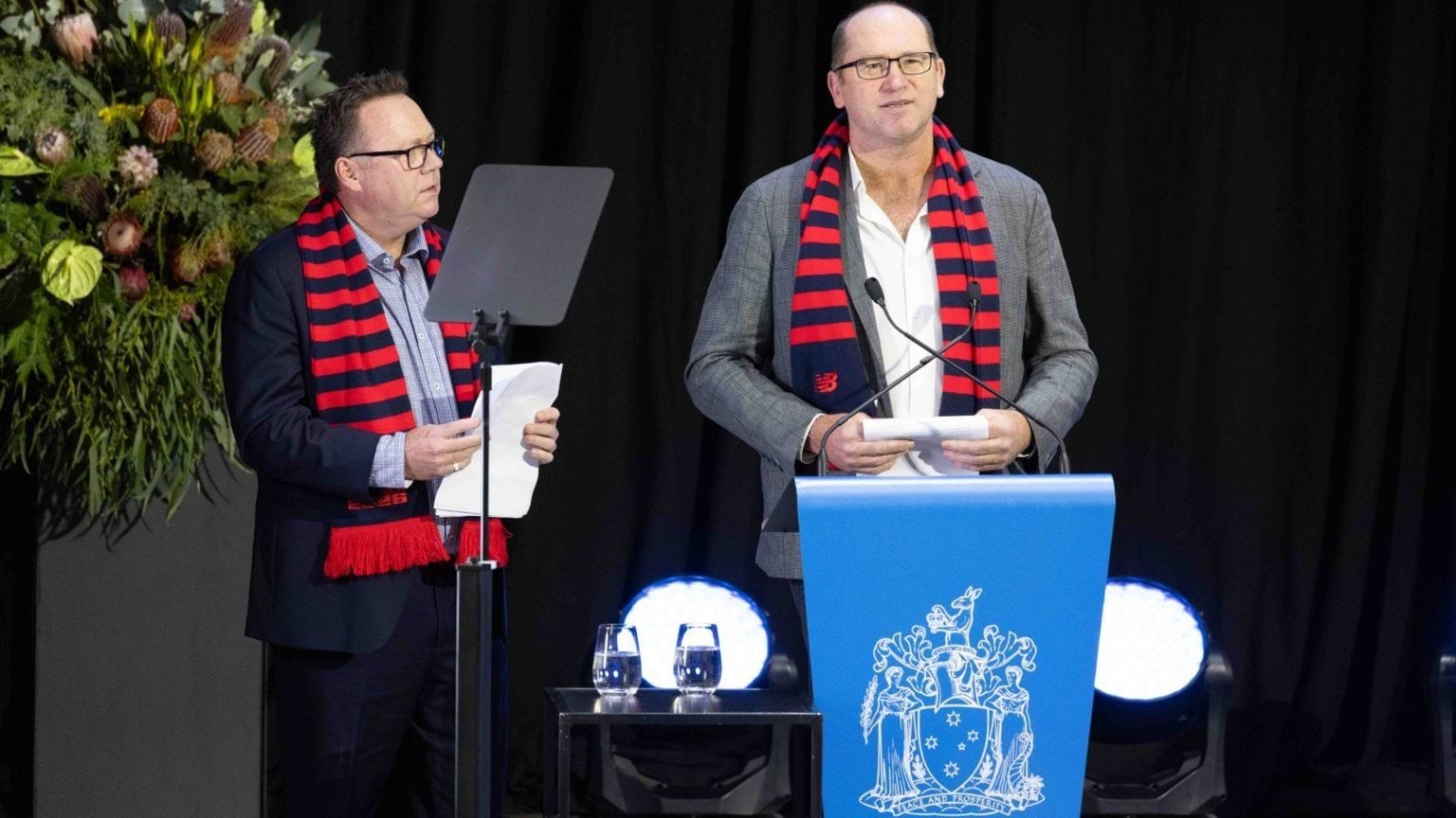 Former Melbourne footballers Paul Hopgood and David Neitz speak at Neale Daniher AO's State Funeral Service