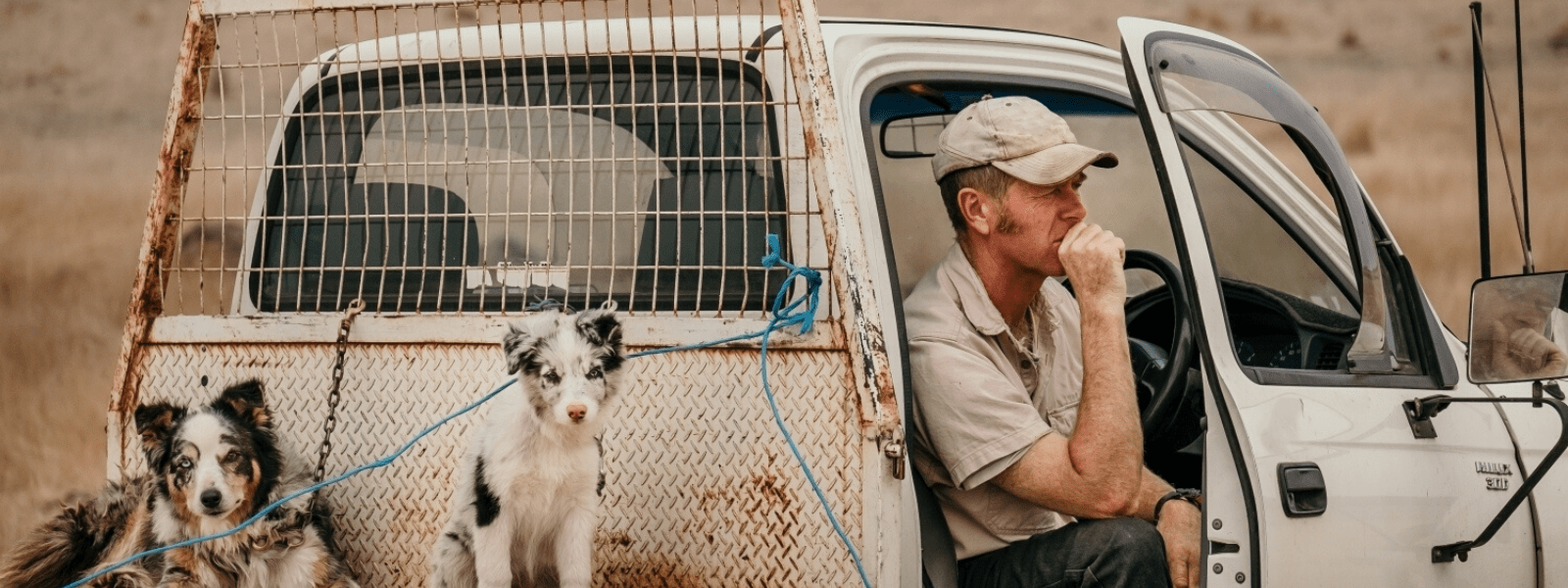 A man getting out of a burnt out utility vehicle