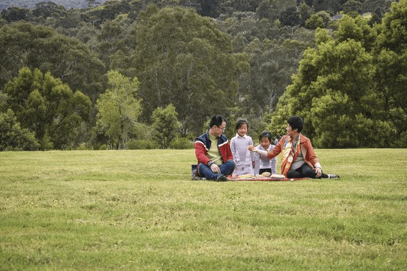 Family sitting in the Yarra valley parklands having a picinic