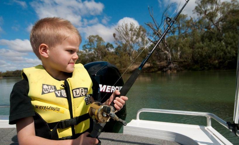 Child fishing in a boat