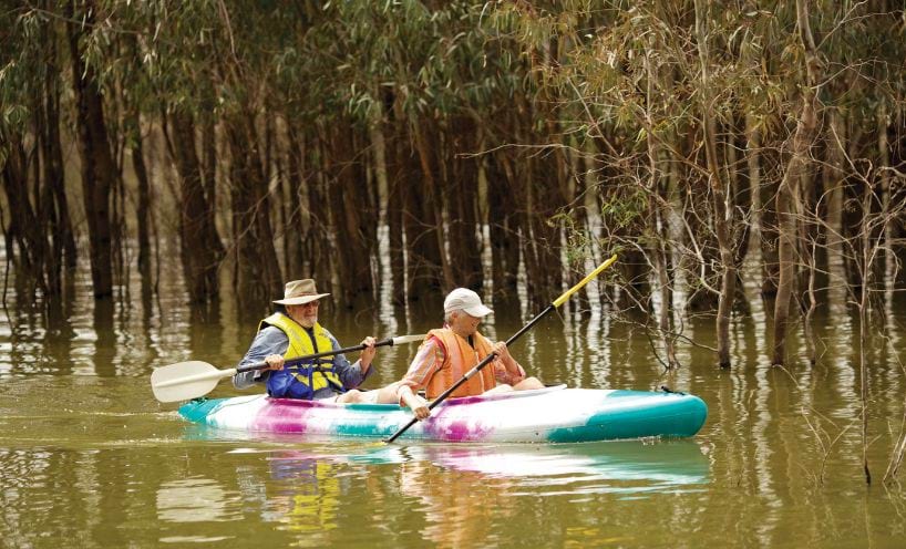 Two people kayaking on a river