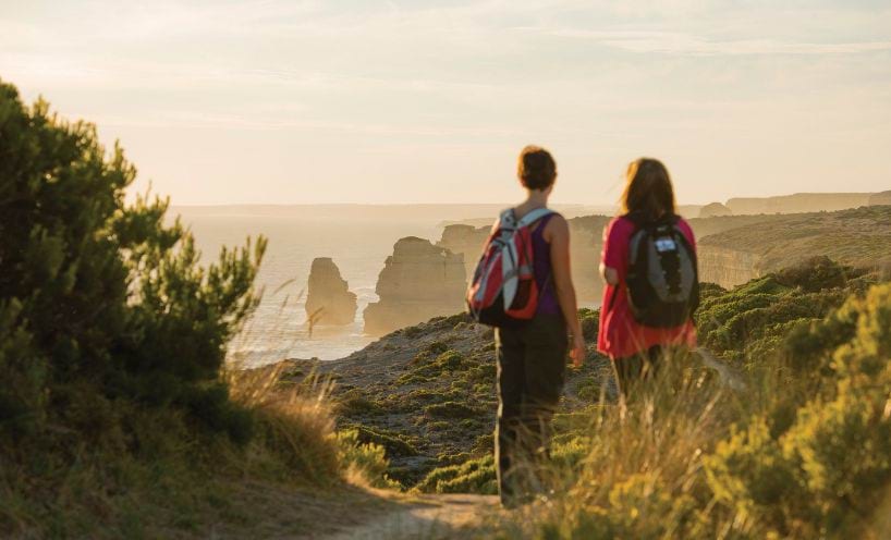 Two people looking at a scenic view while hiking