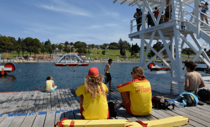 Two lifeguards watching people swim at Eastern Beach