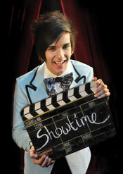 Guy holds a movie clapper with 'Showtime' written on it