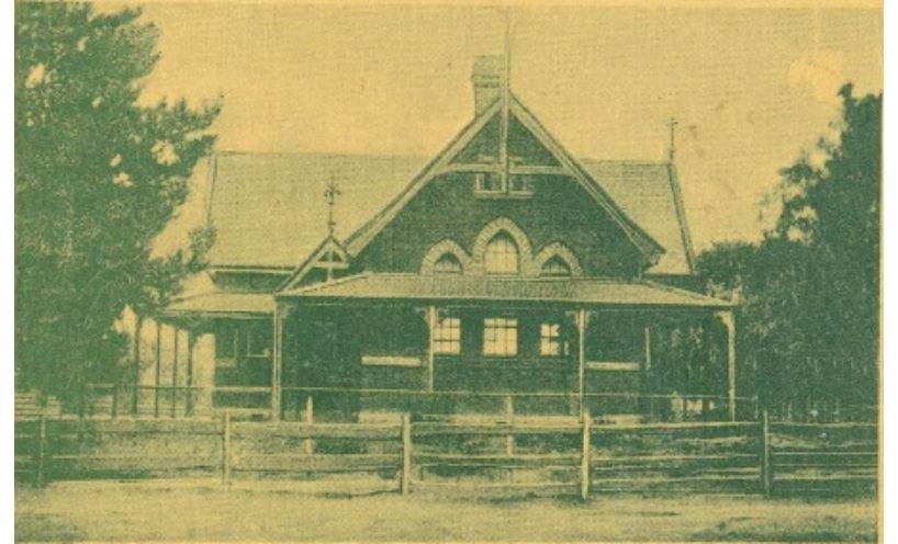 Nagambie State School with wooden post and rail fence around 1970.