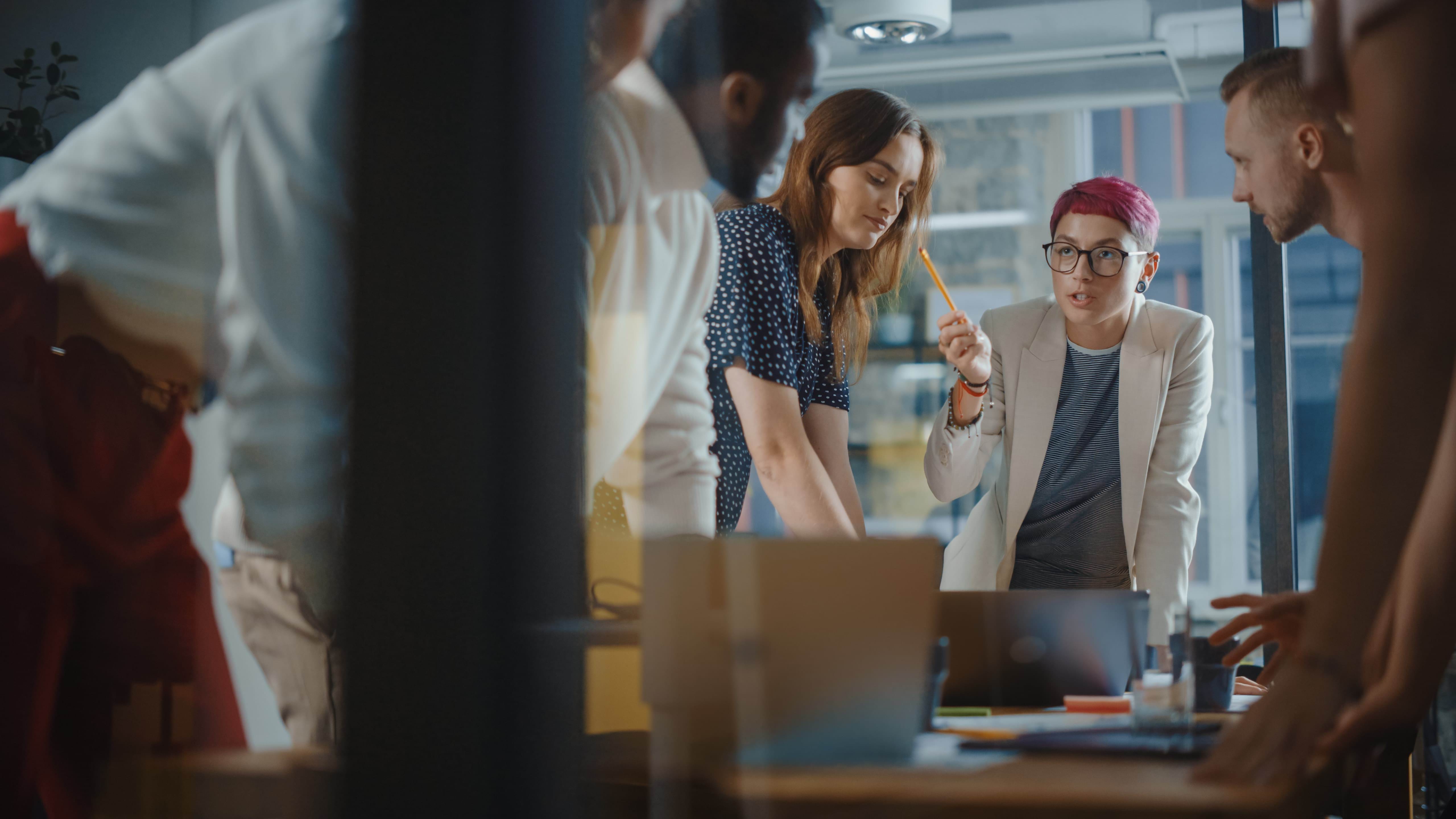 Diverse Team of Professional Businesspeople Meeting in the Office Conference Room. Creative Team Around Table, Specialist with Short Pink Hair Speak for Marketing Compain, Social Media Strategy