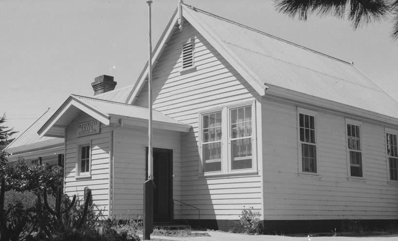 Single storey weatherboard school building with flag post at Freshwater State School