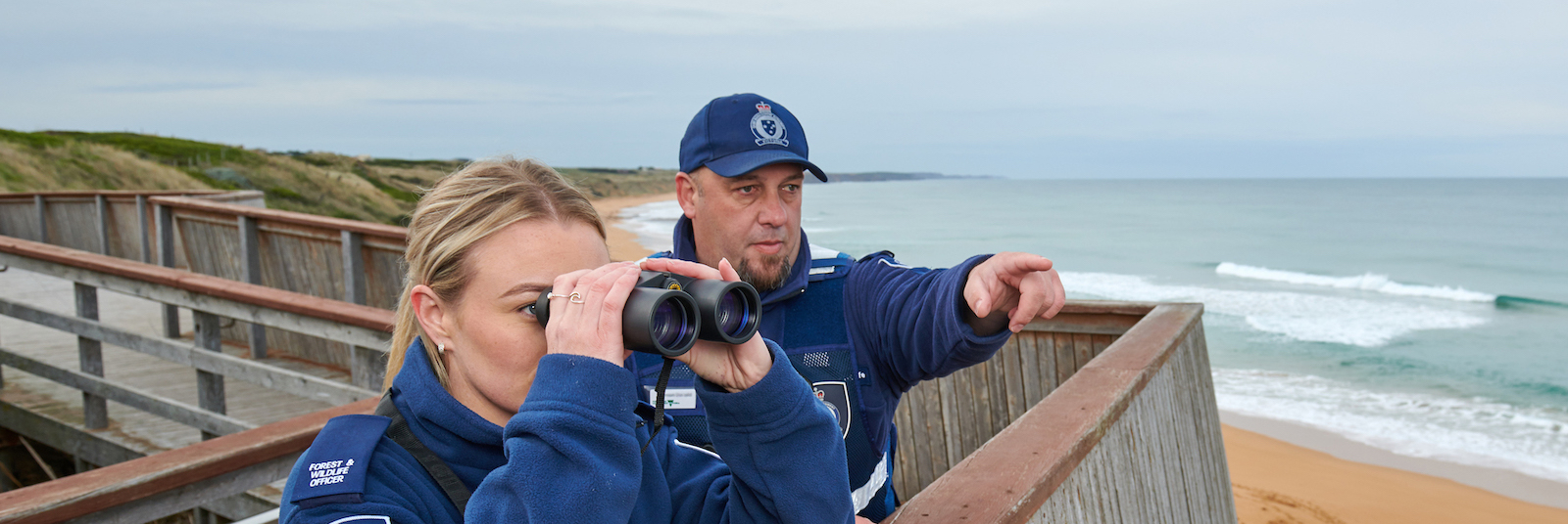 About us Image of officers looking out over the ocean with binoculars