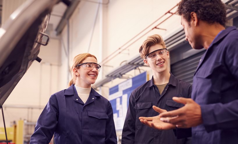 Two automotive apprentices and teacher