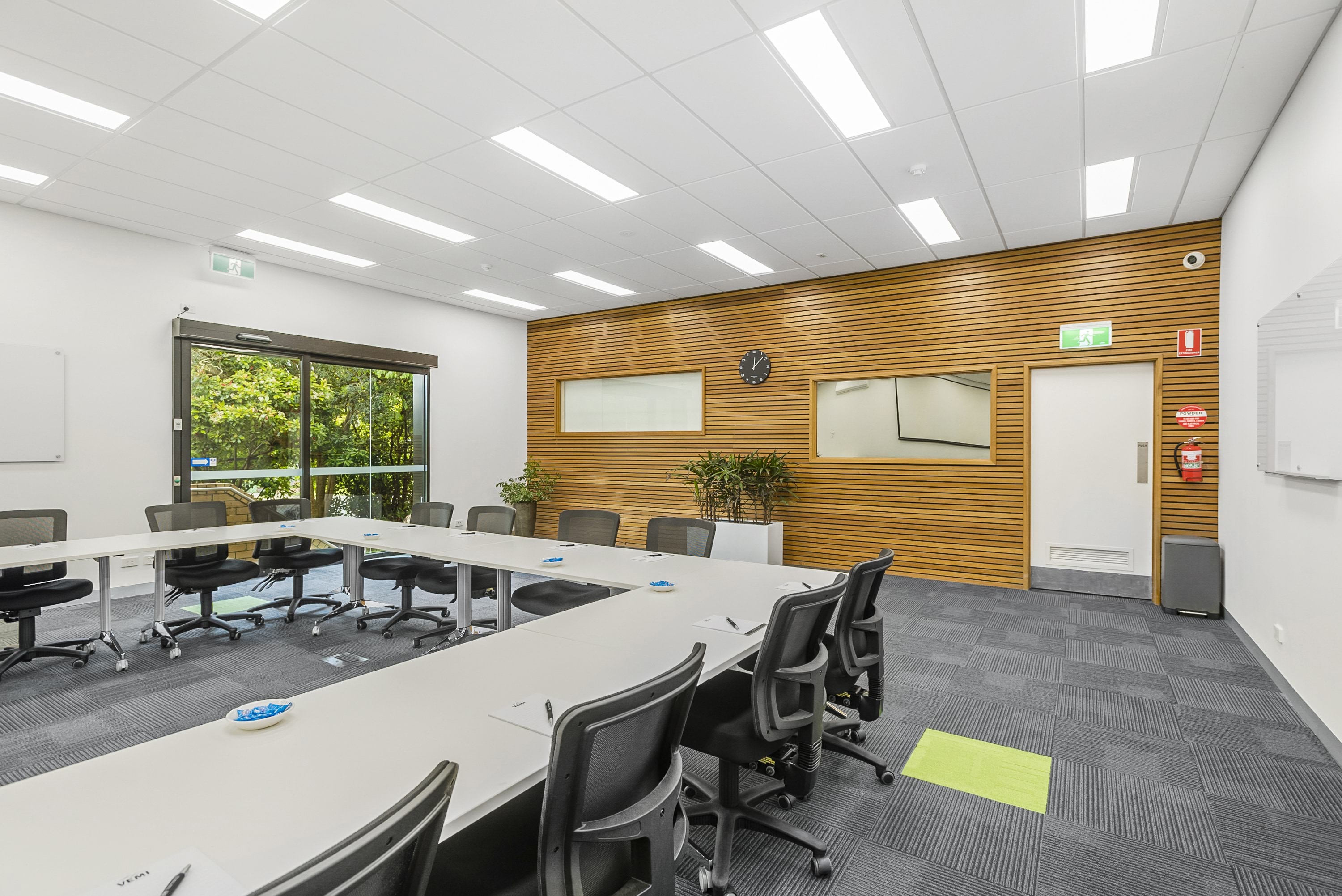 Image shows a meeting room at the VEMI Conference Centre with tables and chairs.