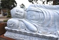 Reclining statue of Buddha with a sacred Swastika on his chest