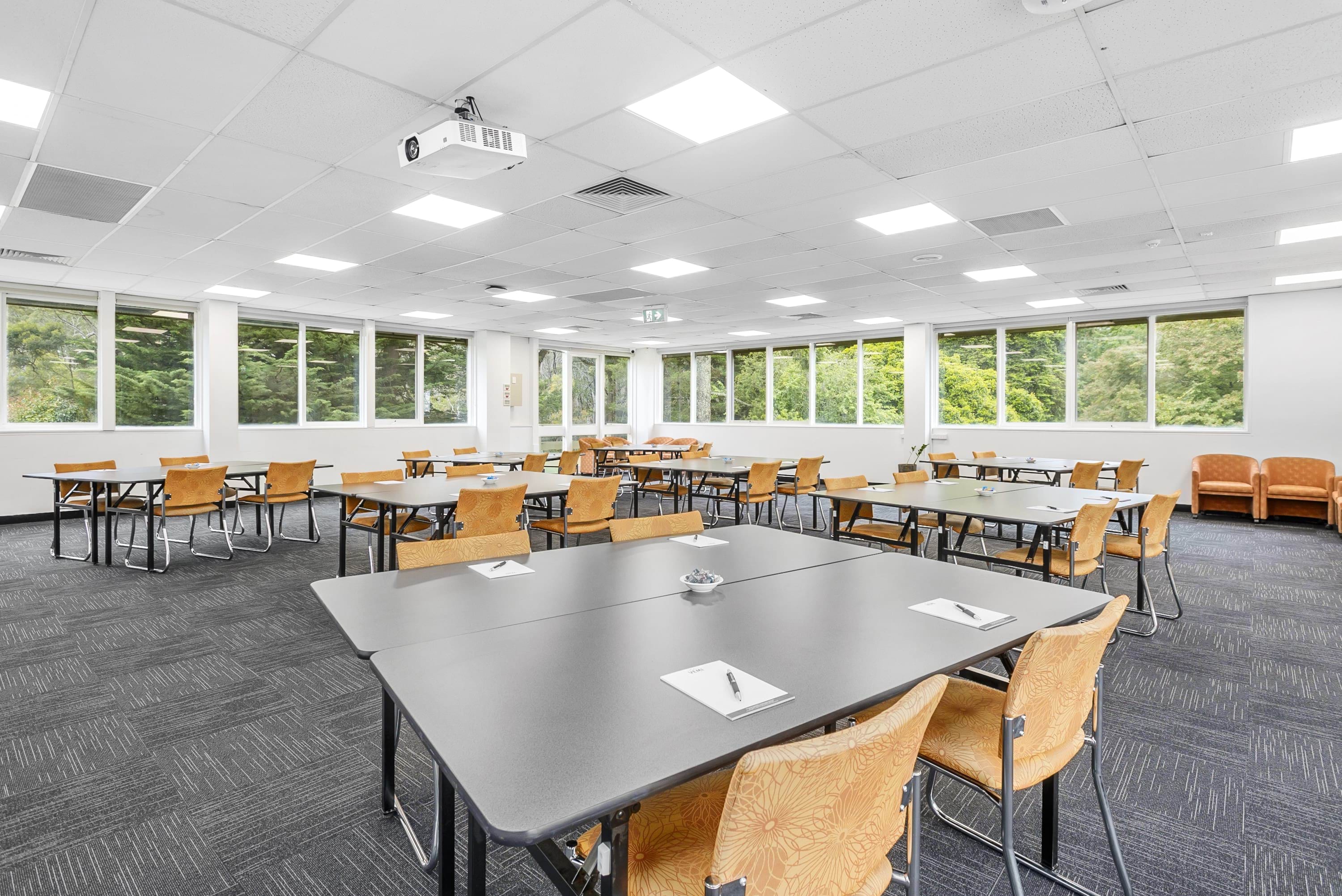 Image shows tables and chairs set out in the Cobaw Room at VEMI Conference Centre