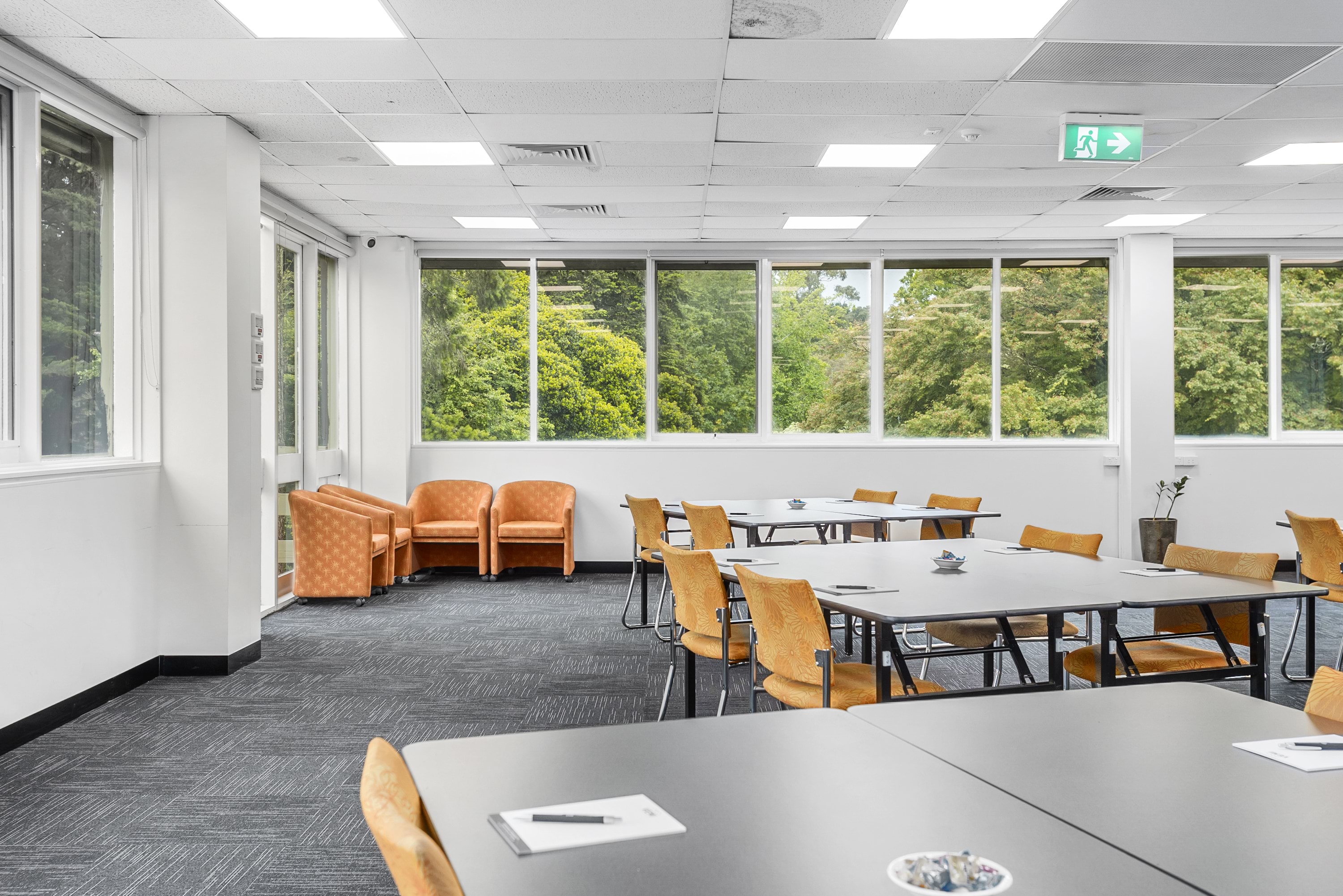 Image shows a meeting room at the VEMI Conference Centre with tables and chairs.