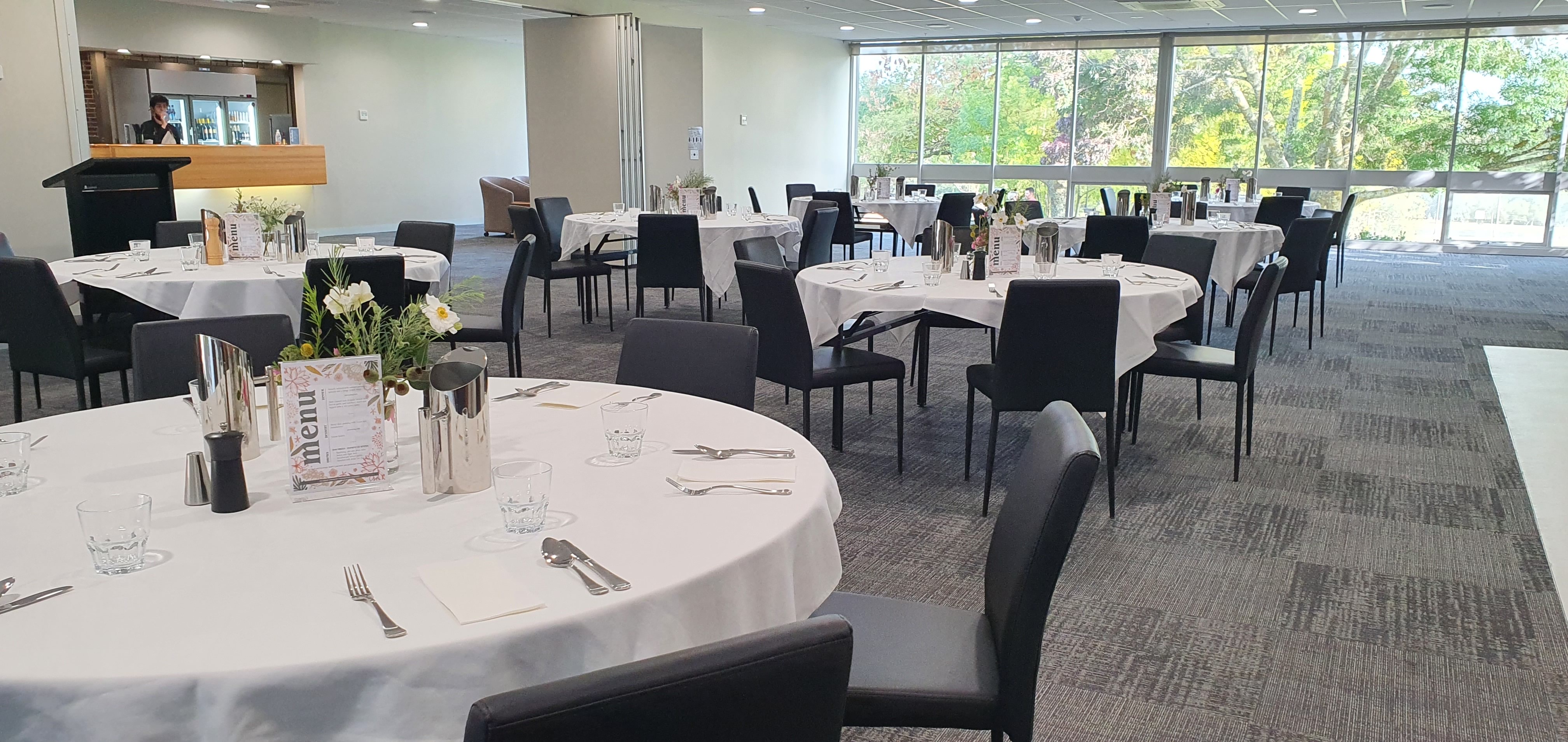 VEMI dining room with chairs around circular tables.