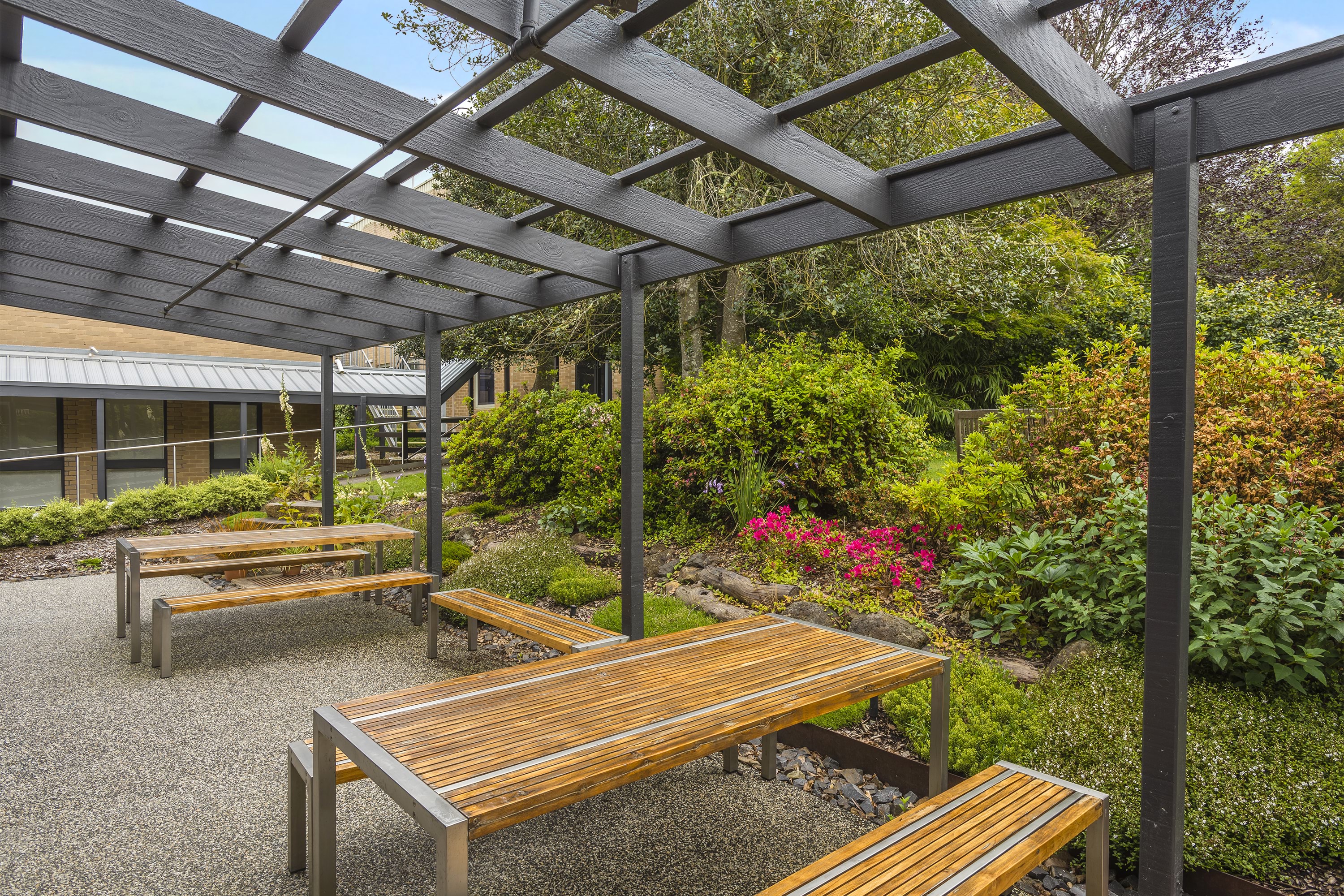 VEMI alfresco dining area showing outdoor tables and a canope