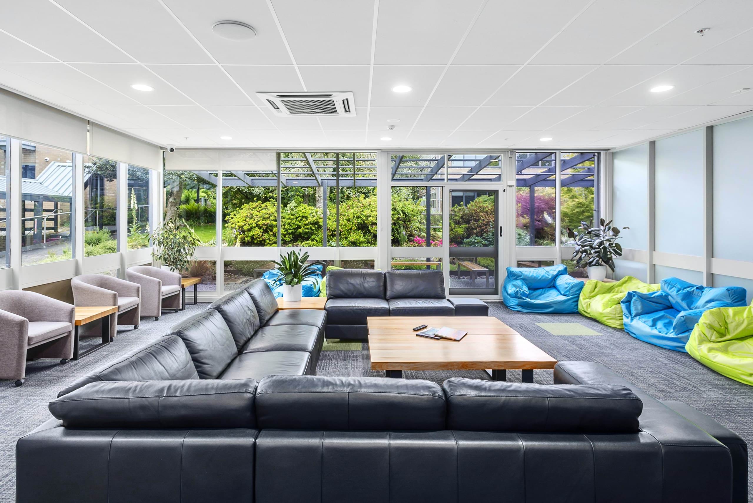 VEMI lounge showing bean bag chairs, a table and a leather couch