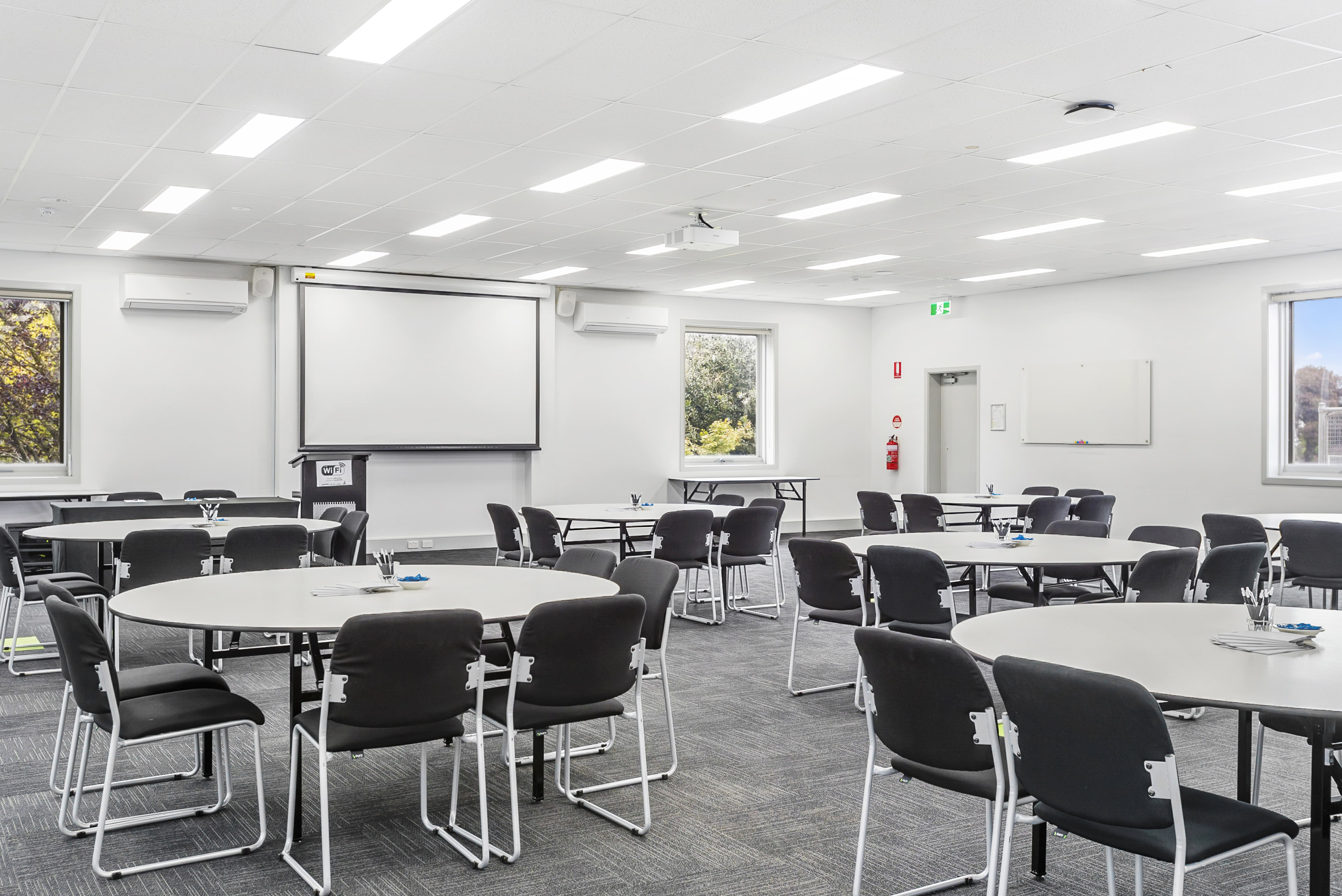 Image shows the Mt View meeting room at the VEMI Conference Centre with a whiteboard, tables and chairs.