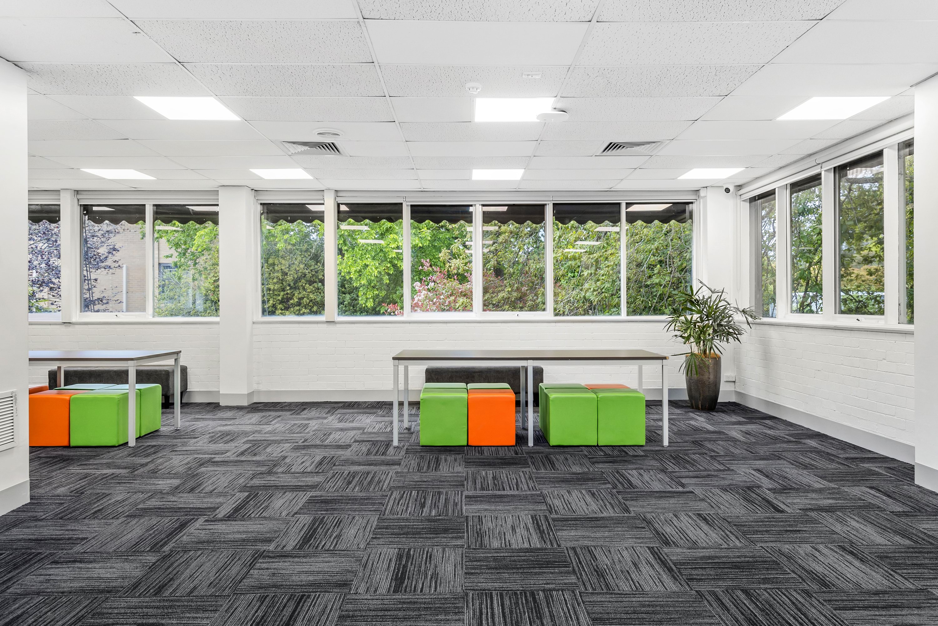 Image shows the Treetops meeting room at the VEMI Conference Centre with tables and chairs.