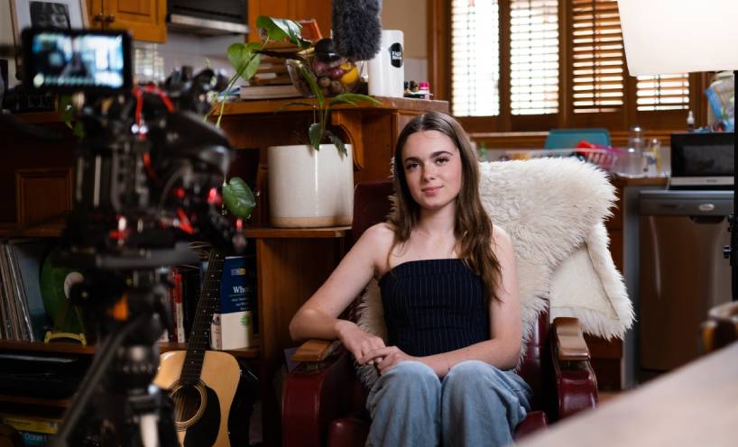 Frankie Mazzone sitting in a chair in front of a video camera