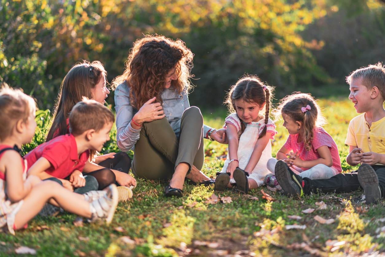 Group of happy children consoling a girl