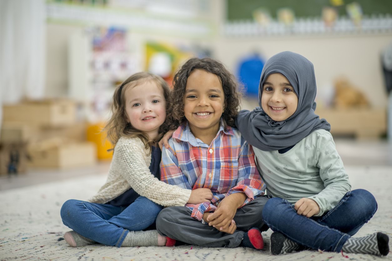 Three children hugging