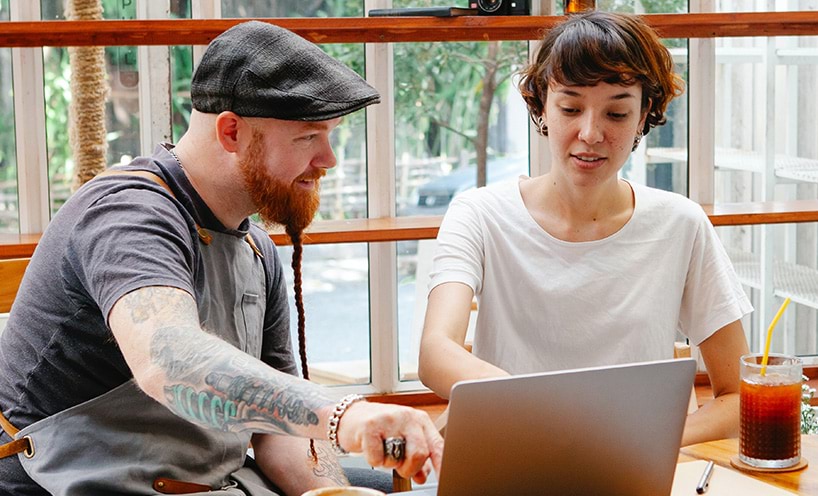 Two people looking at laptop