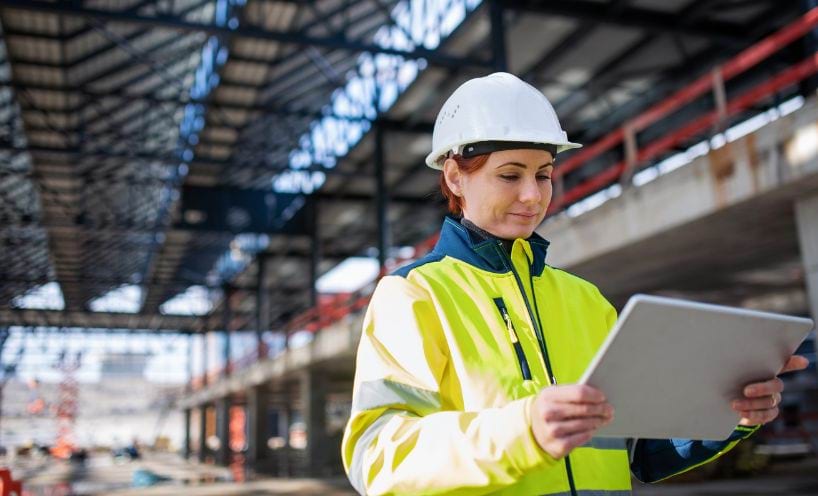 Woman holding tablet on construction site