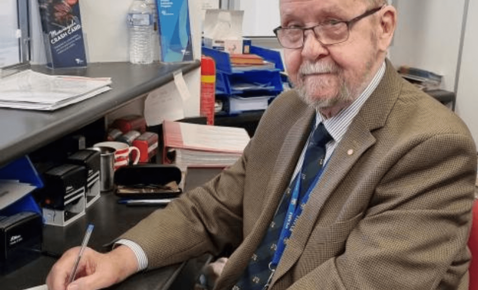 Bob Bolch posing at a desk at the Frankston Police Station DSS, where he has served for 17 years.