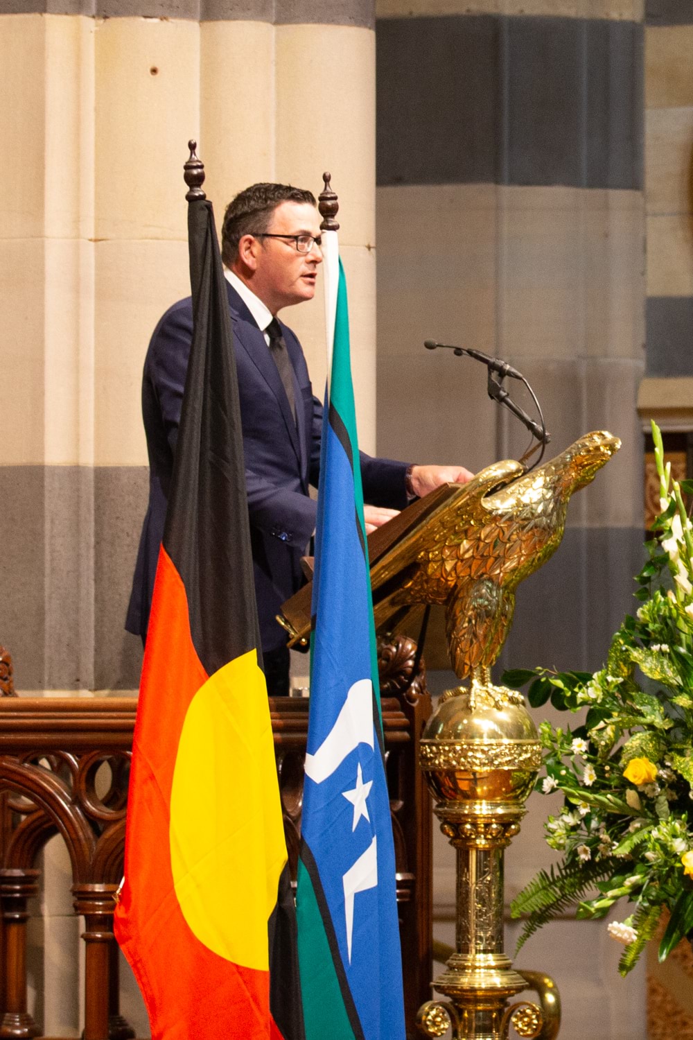 Premier Daniel Andrews standing behind the ornate lectern at St Paul's Cathedral delivering a speech at the memorial for The Honourable John Cain