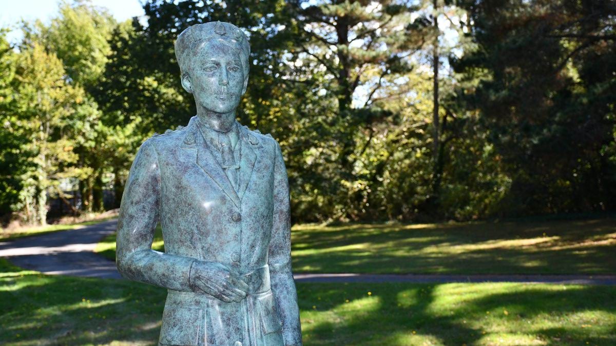 Bronze statue of Dr Vera Scantlebury Brown OBE in the green garden surrounds, in Linton.