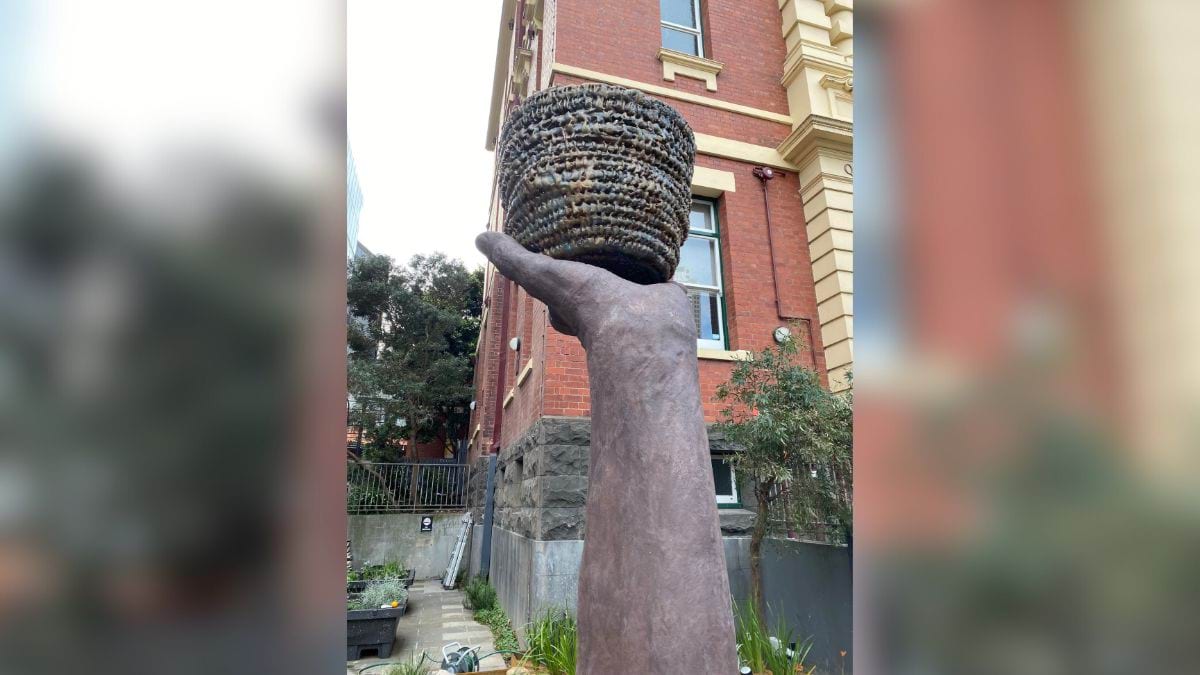 Creative Resilience artwork. A sculpture of a forearm and hand holding a basket.