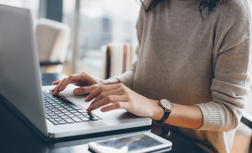 A woman typing on a keyboard