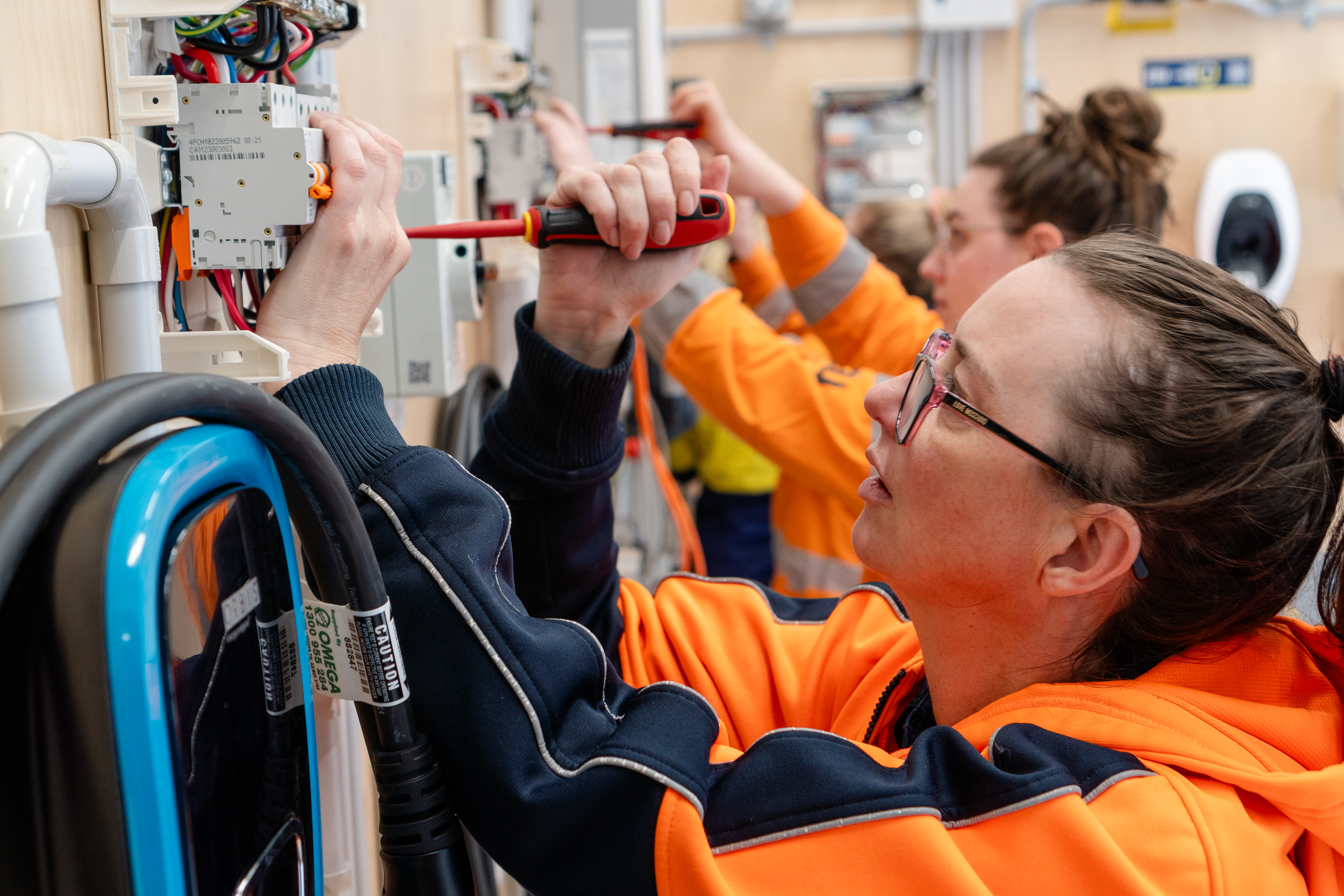 Victorian Training Awards 2023 Community Training Provider of the Year finalist Women in Apprenticeships Victoria (WAVE) showing women using screwdrivers in a trade environment on equipment