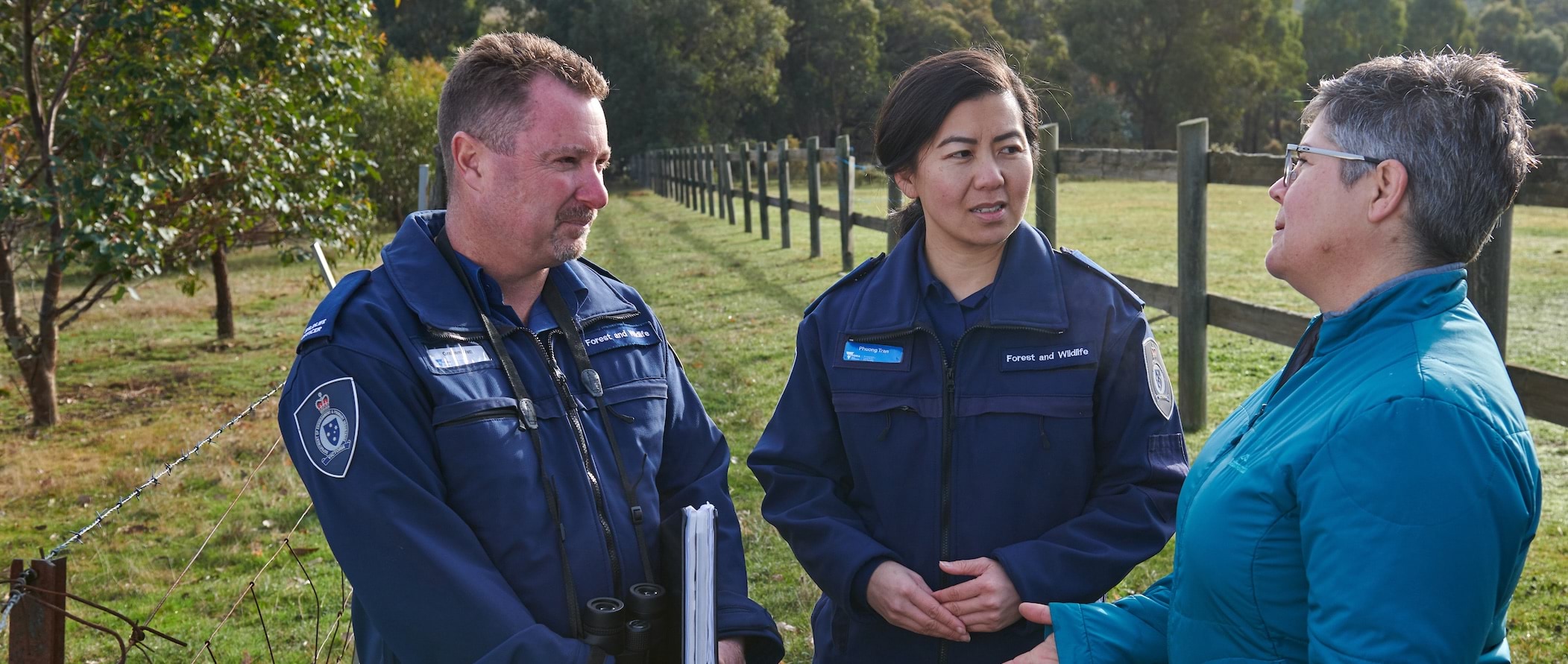 Photo of wildlife officers talking to a lady