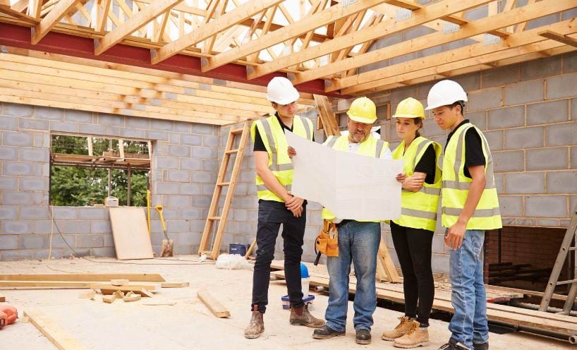 Trades people standing in construction site