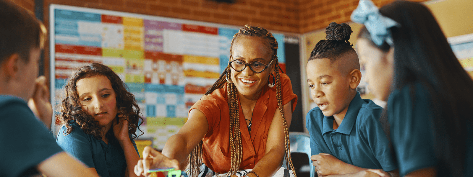 Female teacher with students working with building blocks.