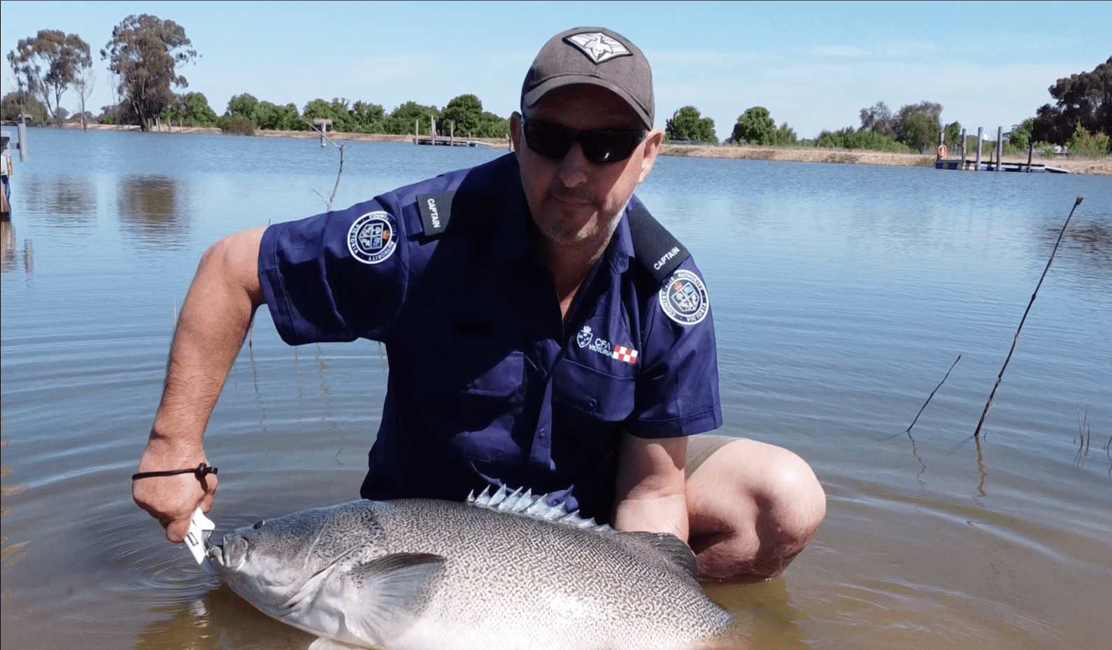 Image shows a man holding a fish he caught in Dunyak Moira fishing lakes