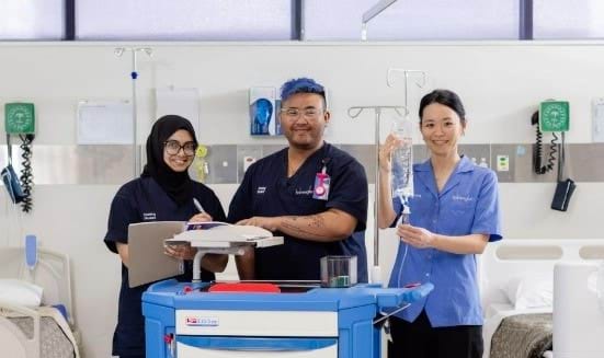 Two female and one male nursing student in a practical class at TAFE