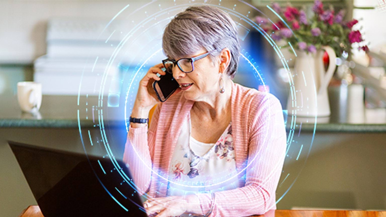 Get help Woman using laptop and phone to get help following a cybersafety incident