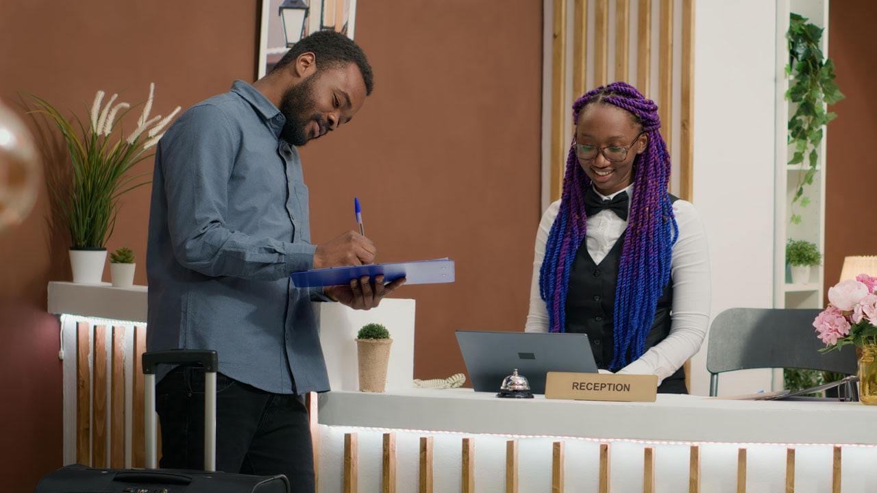 Two people at a reception desk