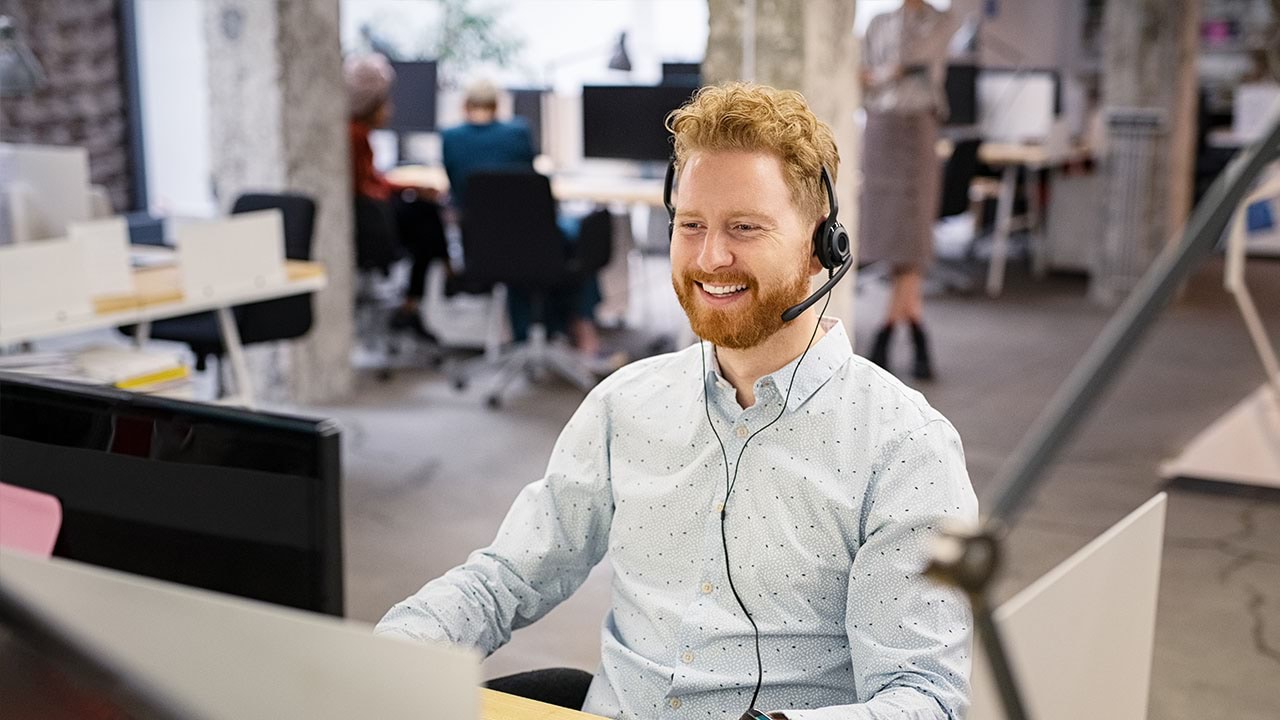 Person working on computer wearing a headset