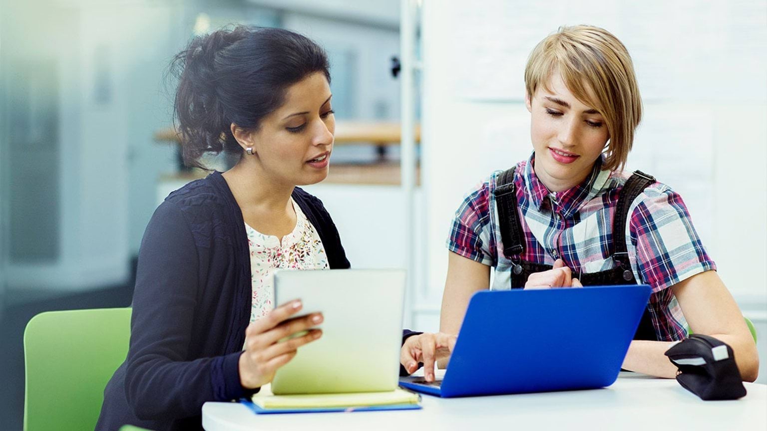 Two people looking into laptop together