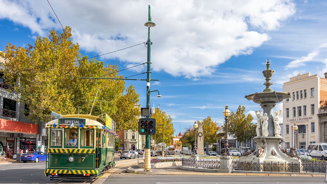 Street scene in Bendigo with tram and water fountain