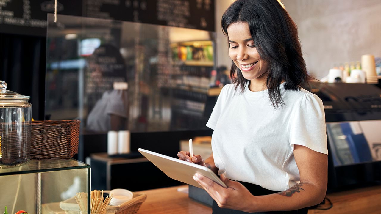 Person using hand held device in cafe setting