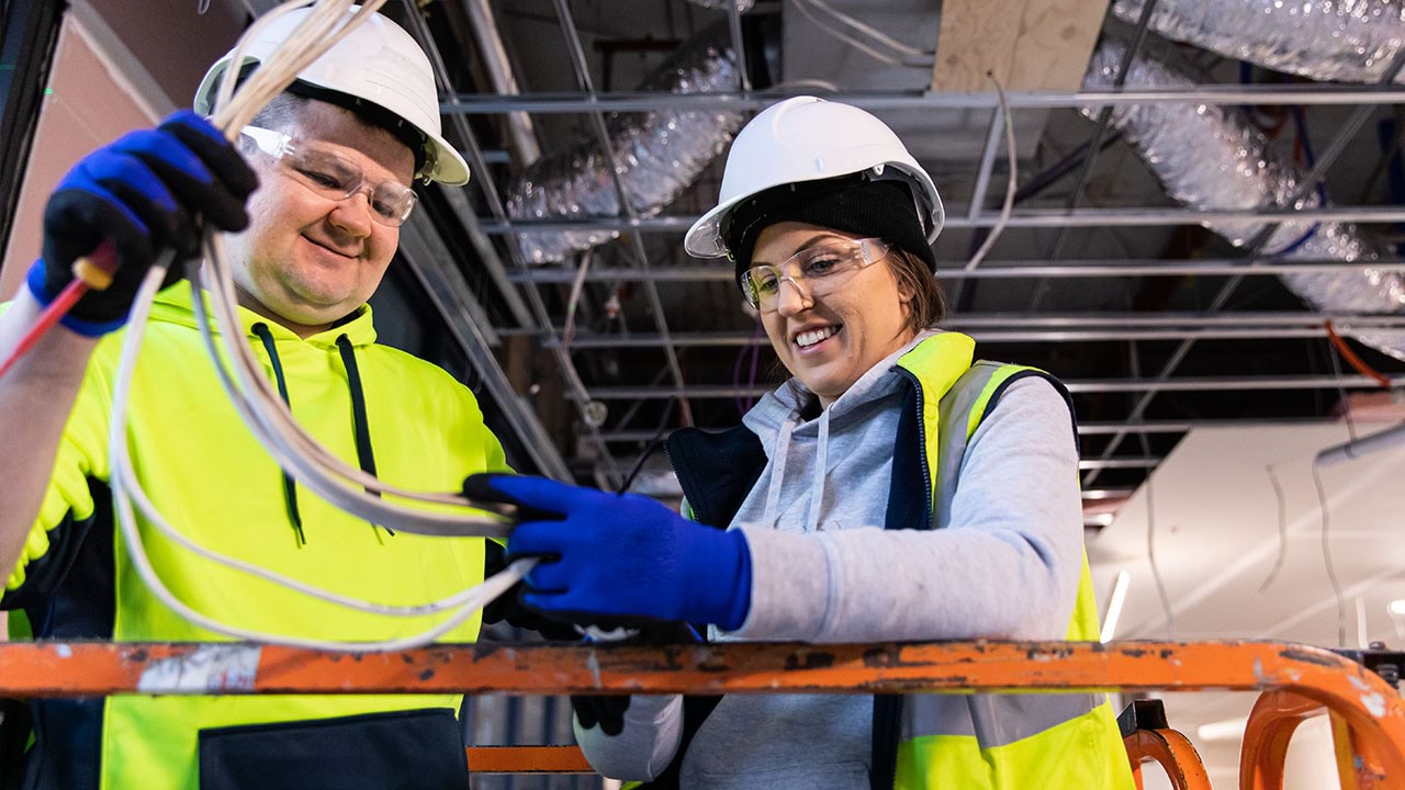 Two people working on cabling