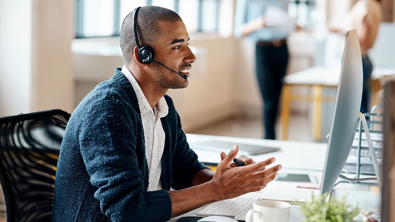 Person in modern office setting wearing headset