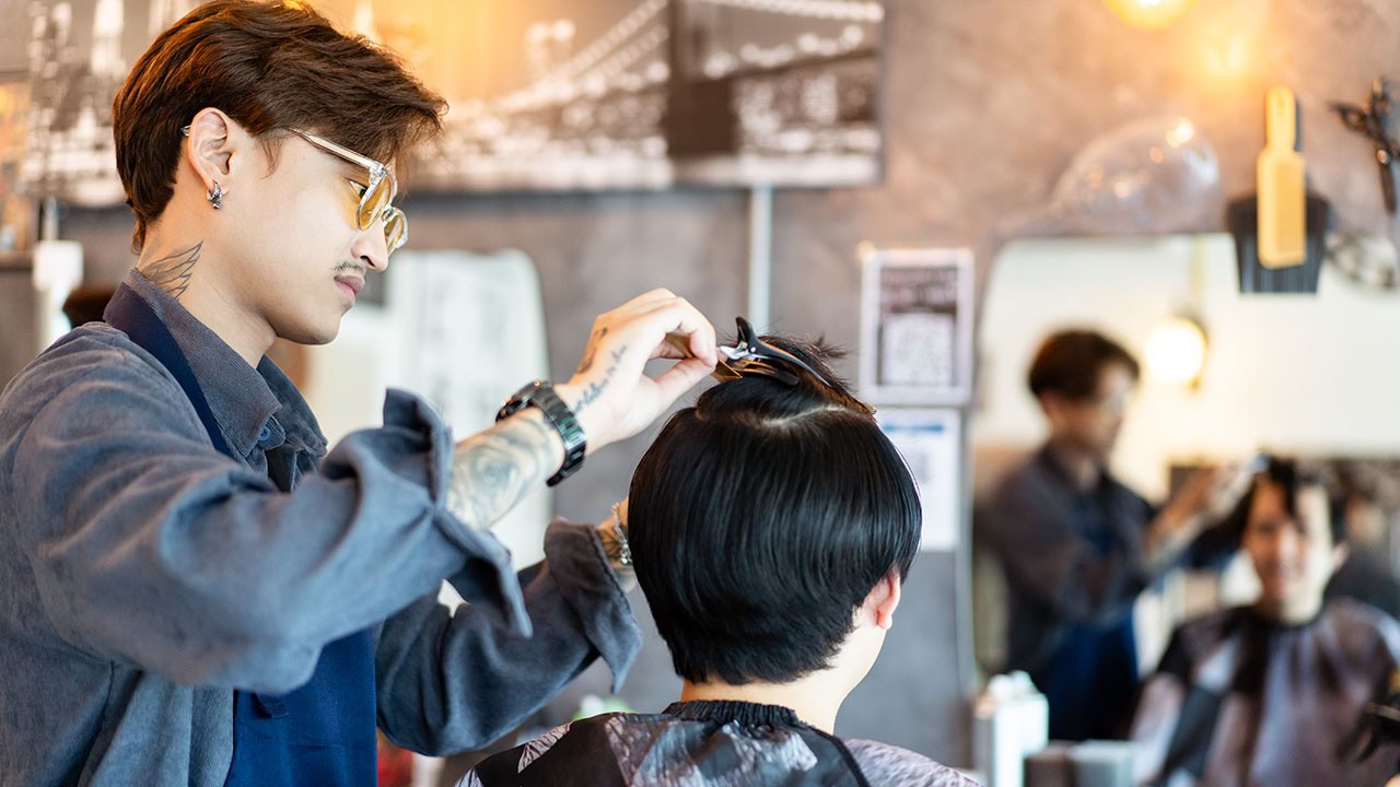 Hairdresser cutting clients hair