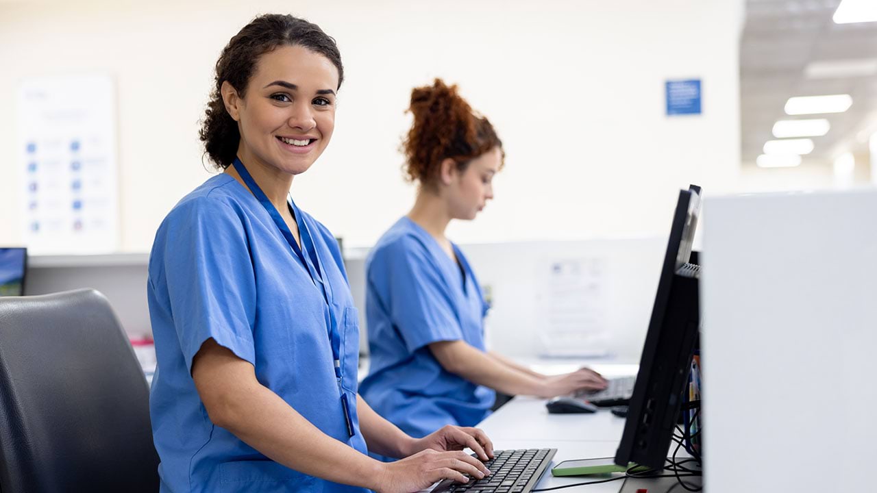 Health care worker at computer station