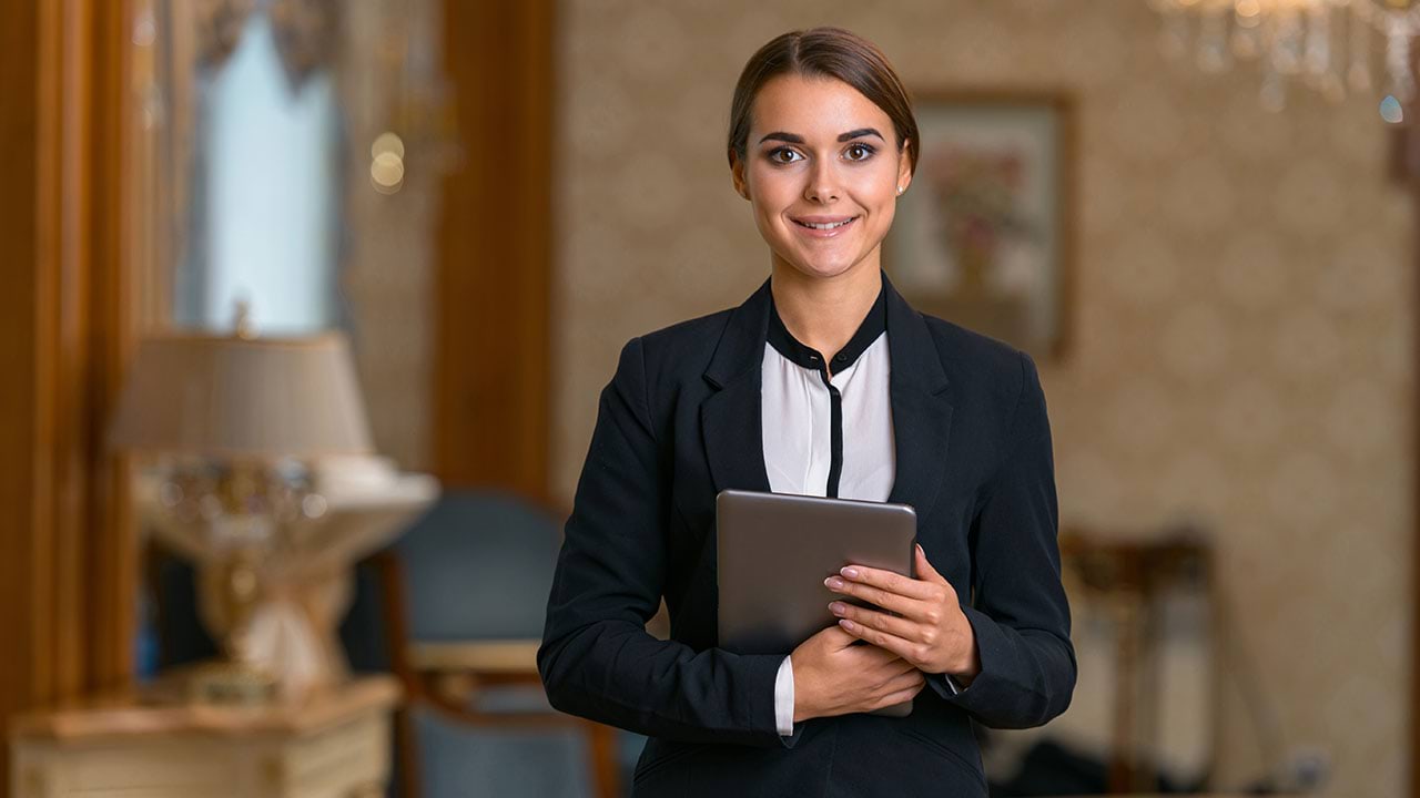 Hotel manager holding a device