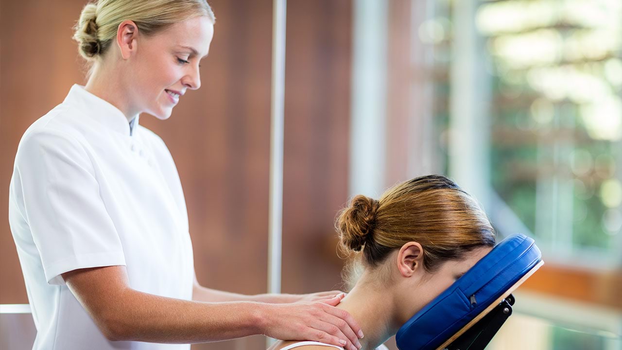 Massage therapist working on client